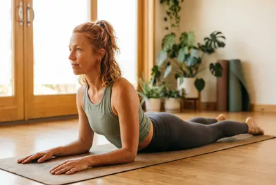 Ava in Sphinx Pose, forearms flat on the mat with elbows under the shoulders