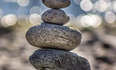 Stack of balanced stones on a beach with a soft bokeh background